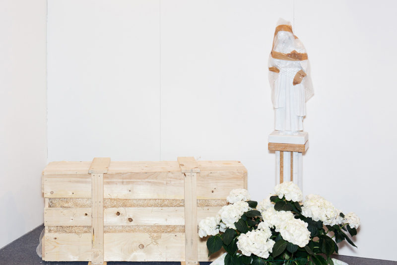 Besides Faith – Wrapped Madonna Next To A Wooden Box